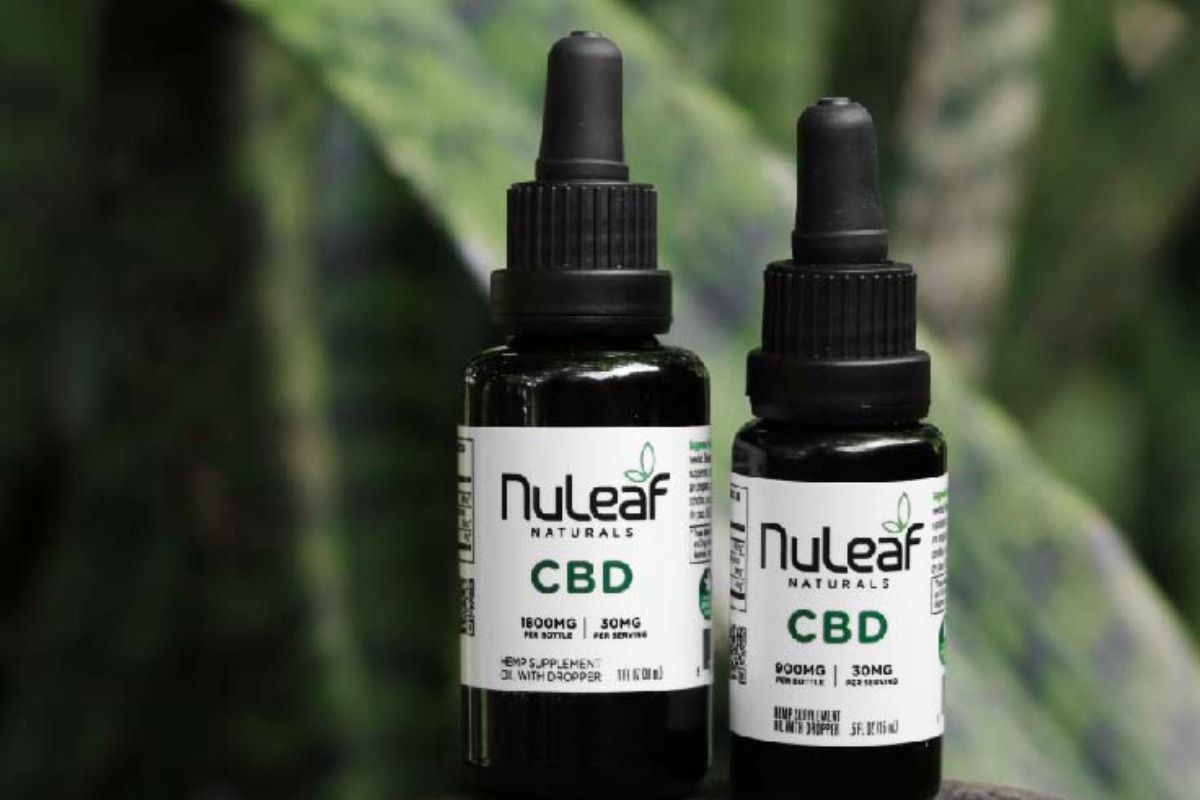 two bottles of nuleaf cbd oil with a plant in background