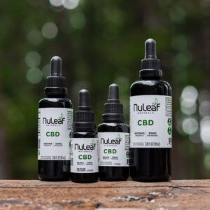 Variety of four different cbd products on a wooden surface